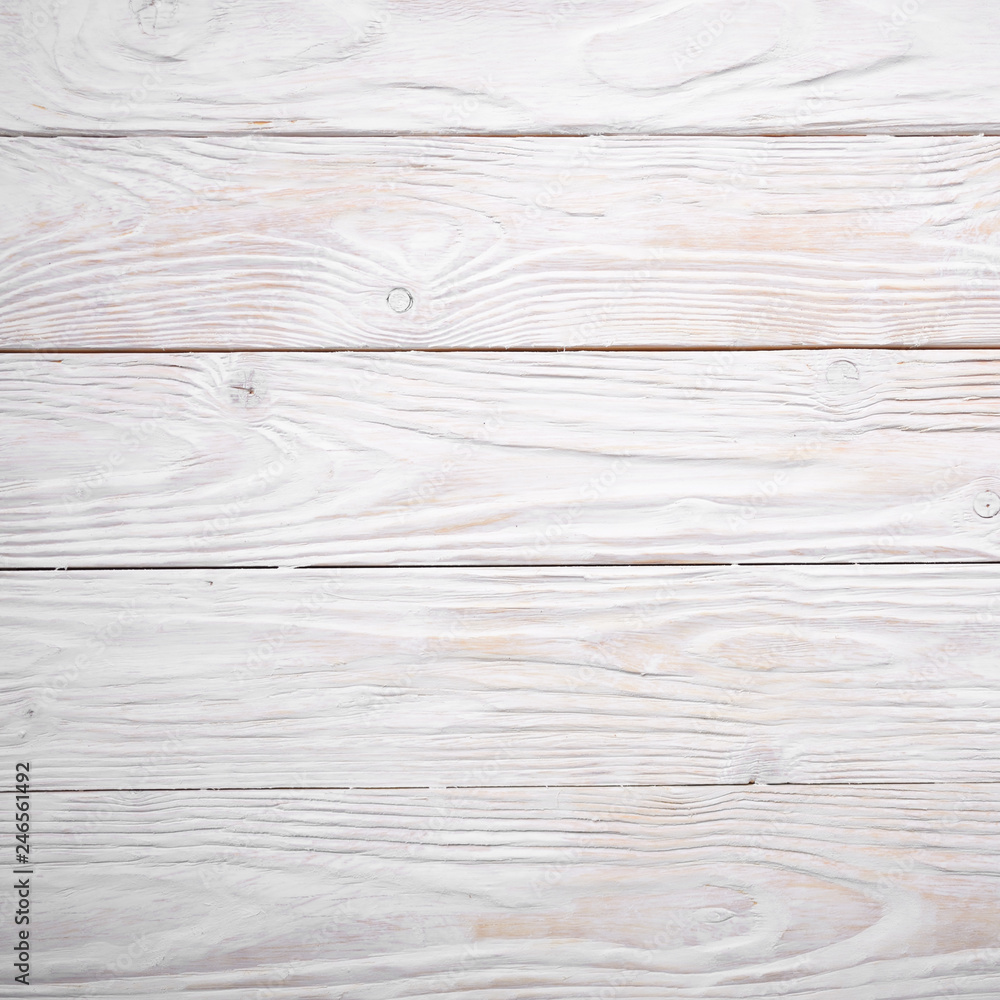 White wooden textured background of flat layed planks with weathered vintage painted surface White wooden textured background of flat layed planks with weathered vintage painted surface