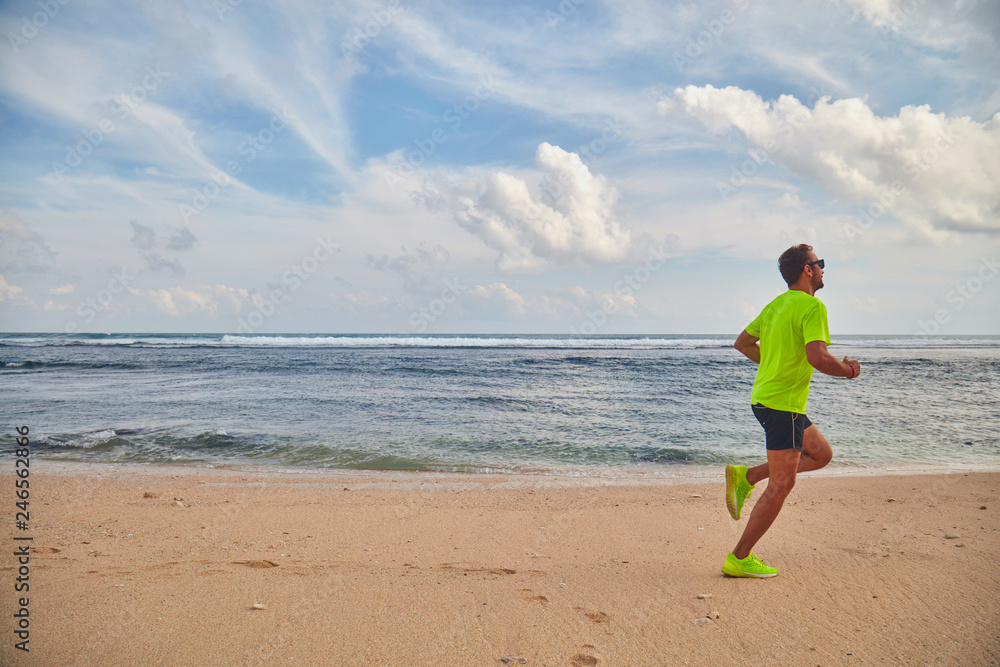 Man running / jogging on a tropical exotic beach. Man running / jogging on a tropical exotic beach.