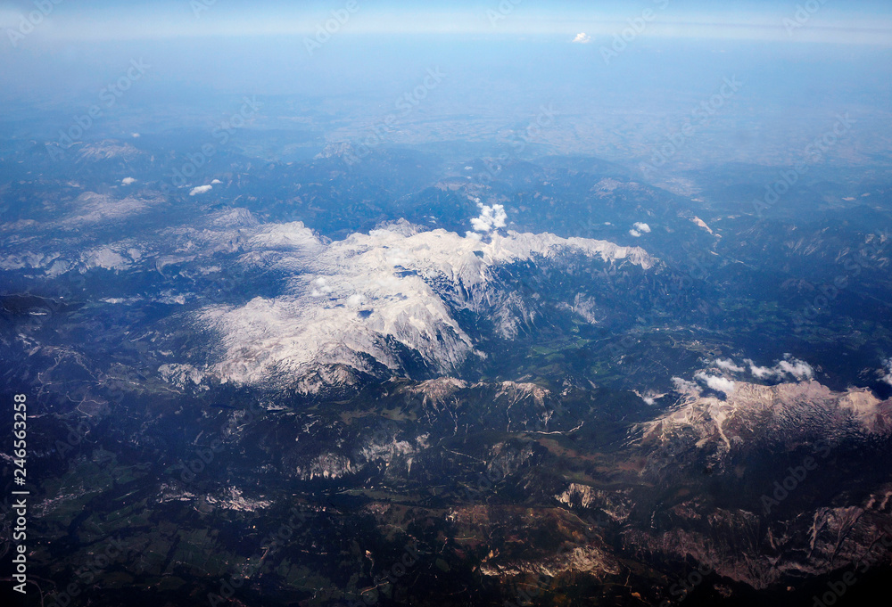 View from the window of the aircraft on the snow-capped peaks of the Alps. View from the window of the aircraft on the snow-capped peaks of the Alps.