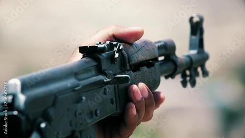 An army soldier holds a gun in his hand (AKM) photo