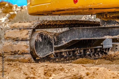 Excavator with caked dirt on its track pad in Utah