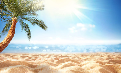 Summer background, nature of tropical beach with rays of sun light. Golden sand beach, palm tree, sea water against blue sky with white clouds. Copy space, summer vacation concept.