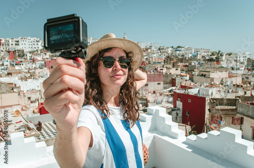 Young happy woman taking selfie on the terrace. Tourist enjoying a vacation in Tangier, Morocco