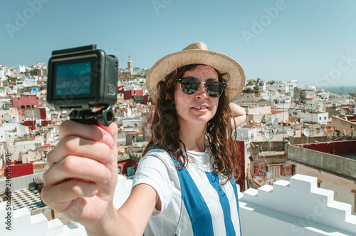 Young happy woman taking selfie on the terrace. Tourist enjoying a vacation in Tangier, Morocco
