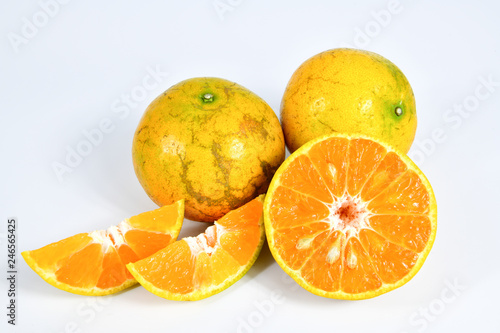 Half and slice of orange on white background.