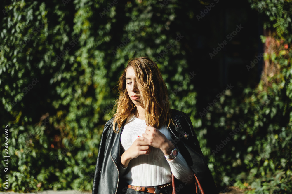 portrait of a young beautiful woman on street, model posing, women's urban street fashion, warm colors portrait of a young beautiful woman on street, model posing, women's urban street fashion, warm colors