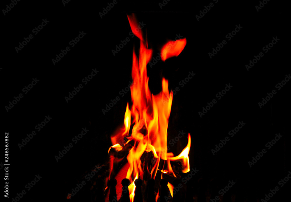 Fototapeta premium High flames in the fireplace on a black background