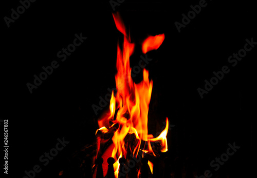 High flames in the fireplace on a black background