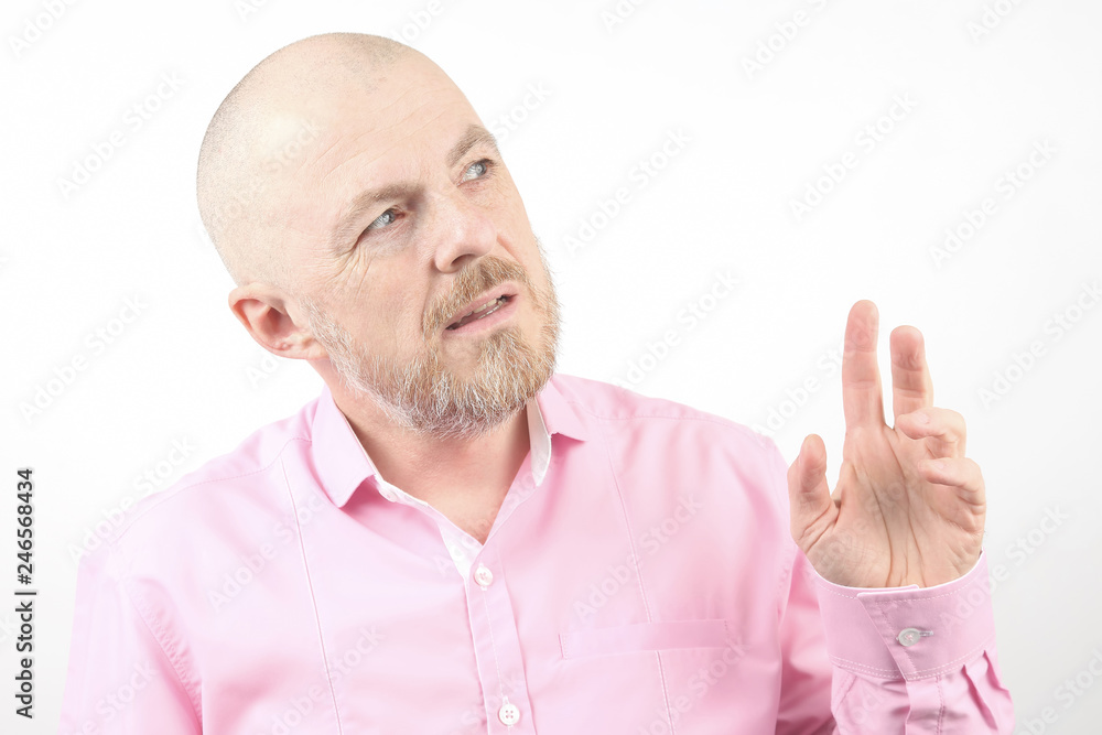 bearded man in a pink shirt with his hand raised bearded man in a pink shirt with his hand raised