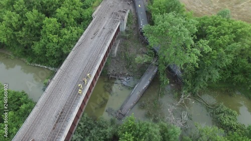 Crude oil tanker cars crash with firemen on railway bridge above photo