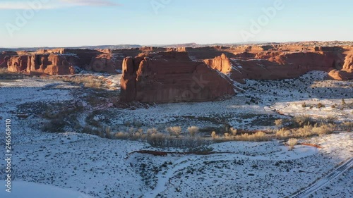 Flying over mountain in Arches National Park covered in snow in winter photo