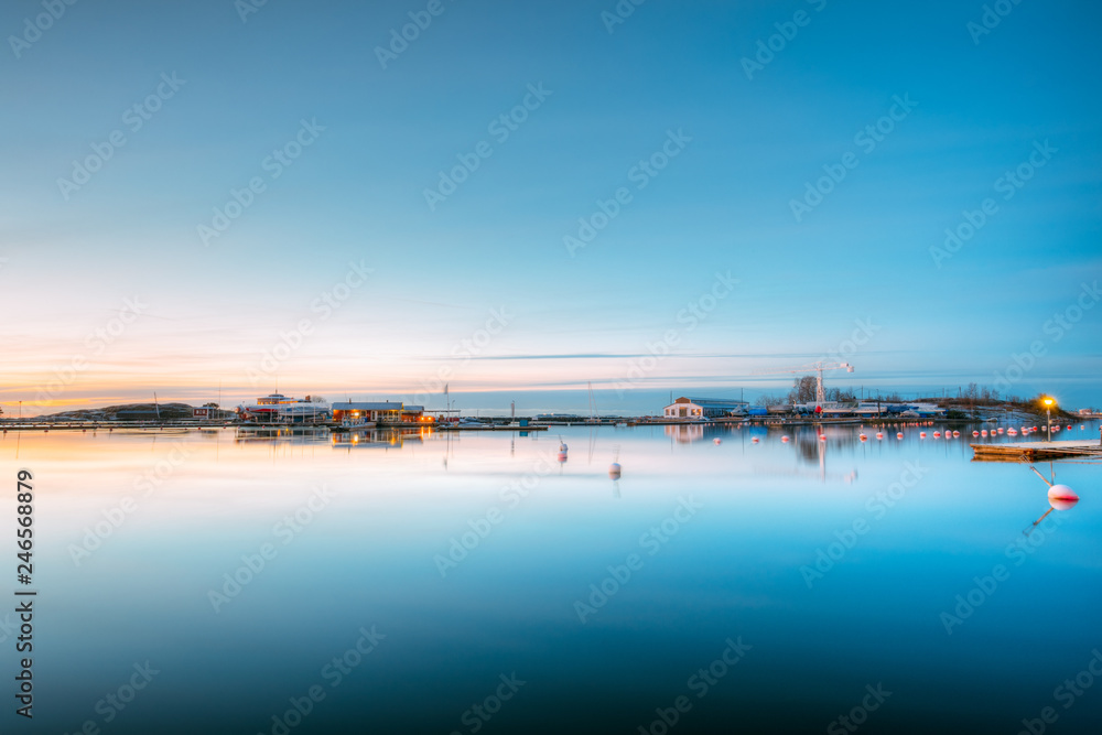 Helsinki, Finland. Landscape With City Pier, Jetty At Winter Sunrise Time.  Tranquil Sea Water Surface At Early Morning