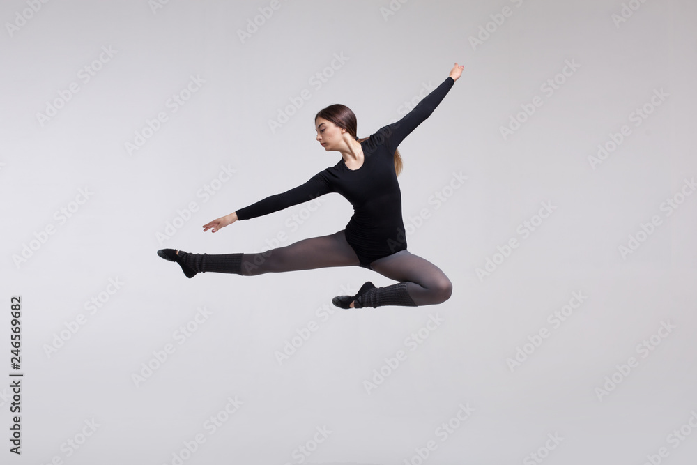 Fototapeta young woman dancer in black swimsuit posing