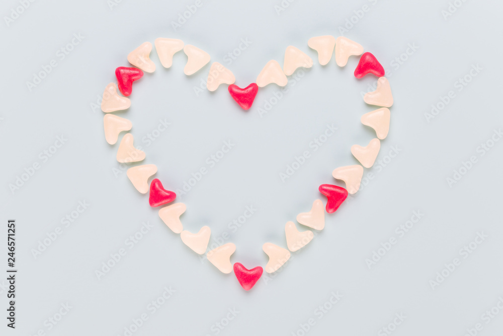 Valentines day background pastel hearts on blue wooden background.