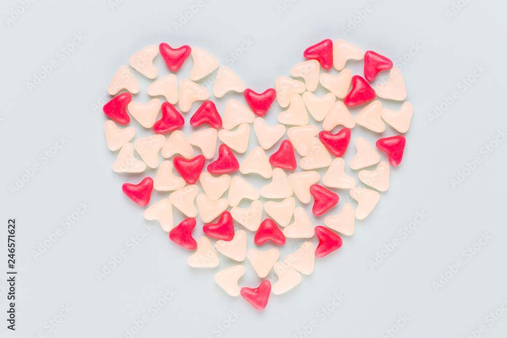 Valentines day background pastel hearts on blue wooden background.