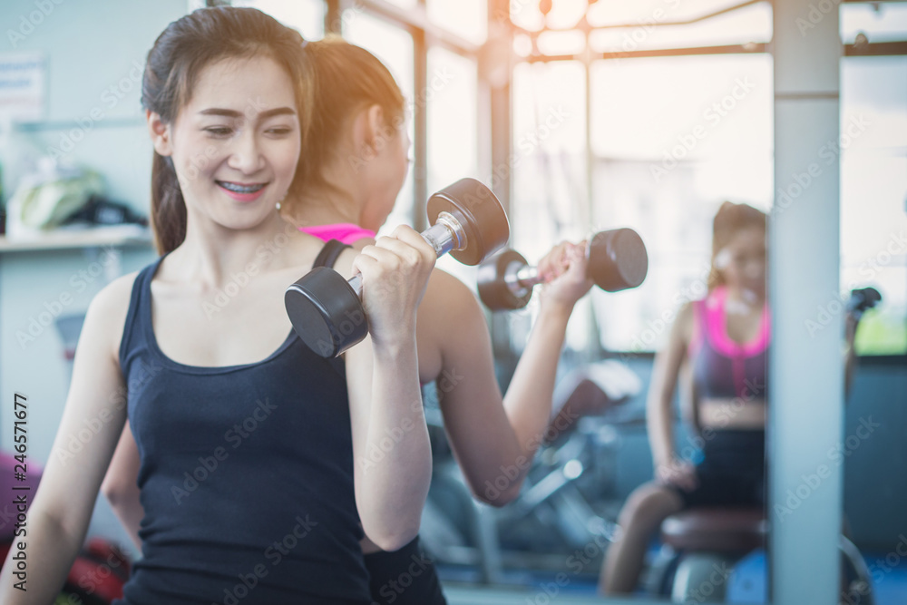 Fototapeta premium fitness woman doing exercises and warm up at gym ; healthy lifestyle