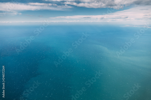 Fototapeta Naklejka Na Ścianę i Meble -  Aerial View From High Altitude Flight Of Aircraft On Sea Ocean Surface. Natural Sea Background