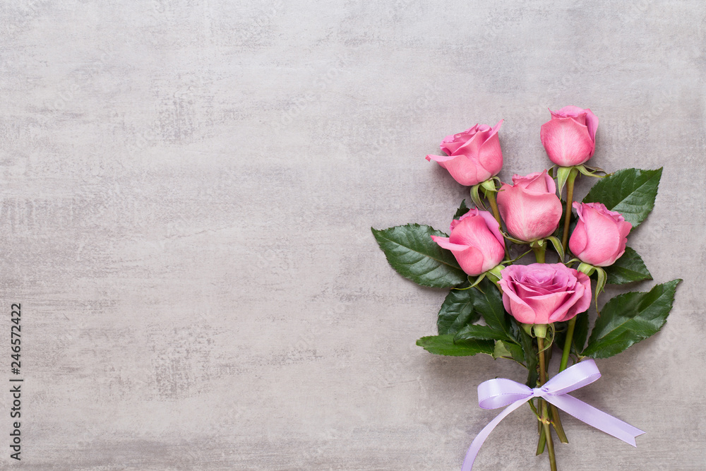 Flowers valentine day composition. Frame made of pink rose on gray background. Flat lay, top view, copy space. Flowers valentine day composition. Frame made of pink rose on gray background. Flat lay, top view, copy space.