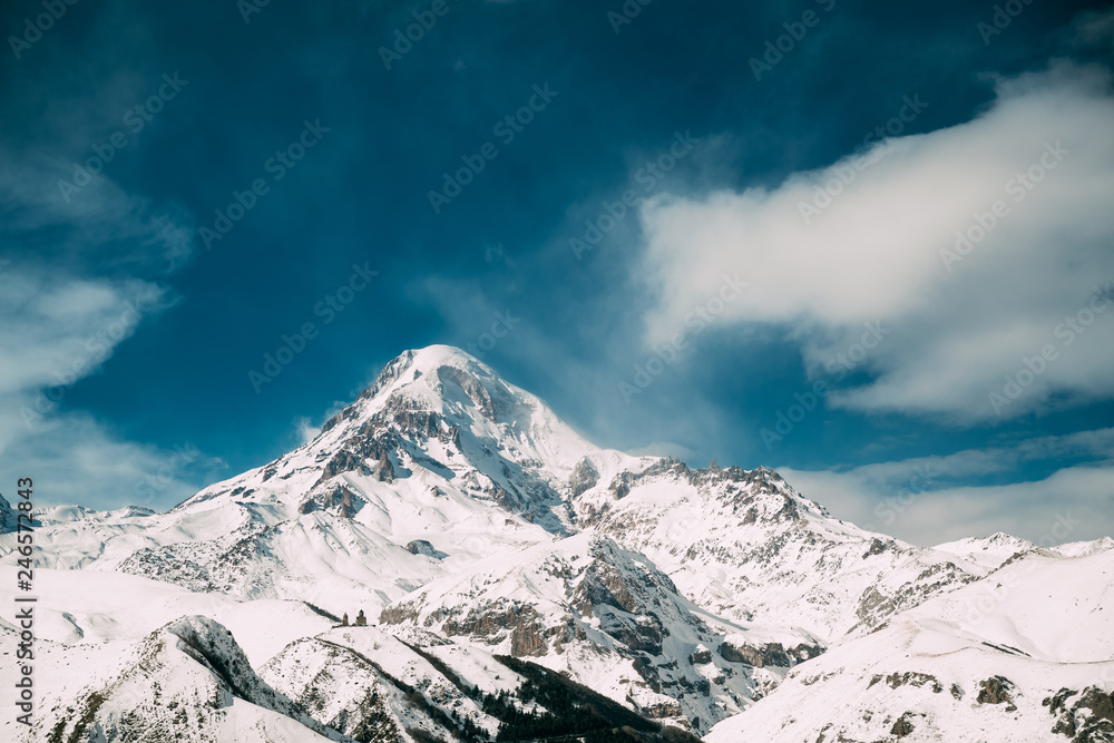 Georgia. Peak Of Mount Kazbek Covered With Snow. Kazbek Is A Stratovolcano And One Of Major Mountains Of Caucasus. Beautiful Georgian Nature Landscape In Early Winter.