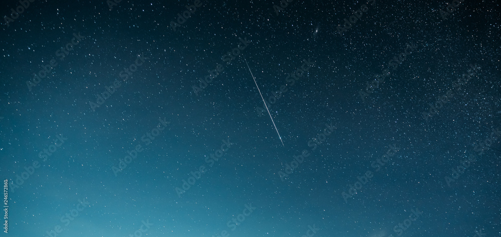 Night Starry Sky With Glowing Stars And Meteoric Track Trail. Meteorite Trail In Starry Sky Background Night Starry Sky With Glowing Stars And Meteoric Track Trail. Meteorite Trail In Starry Sky Background