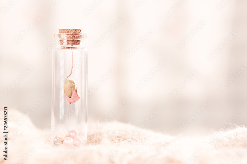 Dried rose flower head in bottle.Very shallow depth of field.Concept background for Valentine's day. Dried rose flower head in bottle.Very shallow depth of field.Concept background for Valentine's day.