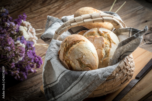 Foto Roll breads in basket on table.