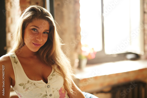 Beautiful russian girl posing for photo in the home loft studio