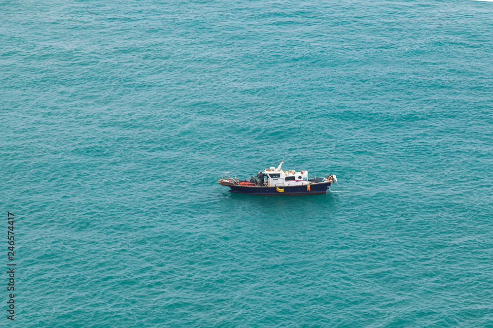 Small fishing motorboat boat goes slowly