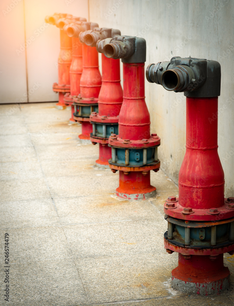 Fire safety pump on cement floor of concrete building. Deluge system of firefighting system. Plumbing fire protection. Red fire pump in front of concrete wall. High pressure fire safety pump. Fire safety pump on cement floor of concrete building. Deluge system of firefighting system. Plumbing fire protection. Red fire pump in front of concrete wall. High pressure fire safety pump.