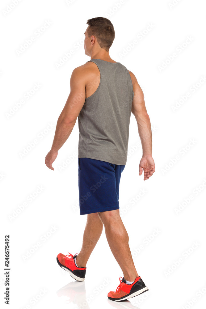 Walking Man In Sport Clothes. Rear Side View. Walking Man In Sport Clothes. Rear Side View.