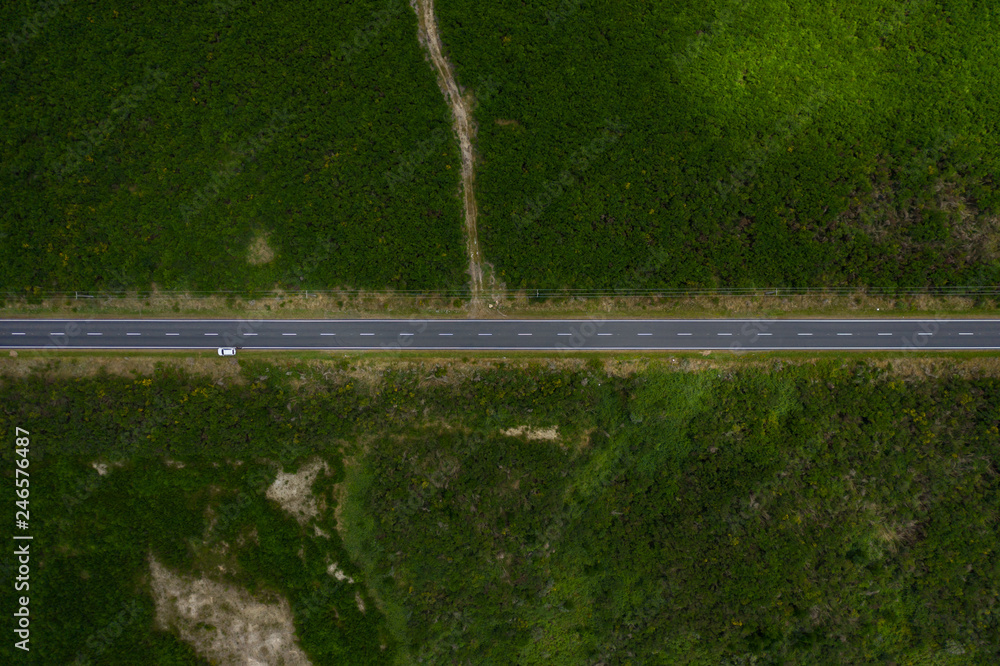 Horizontal road traveling through frame, Aerial top down view 