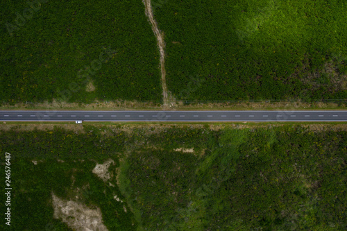 Quadro su tela Horizontal road traveling through frame, Aerial top down view