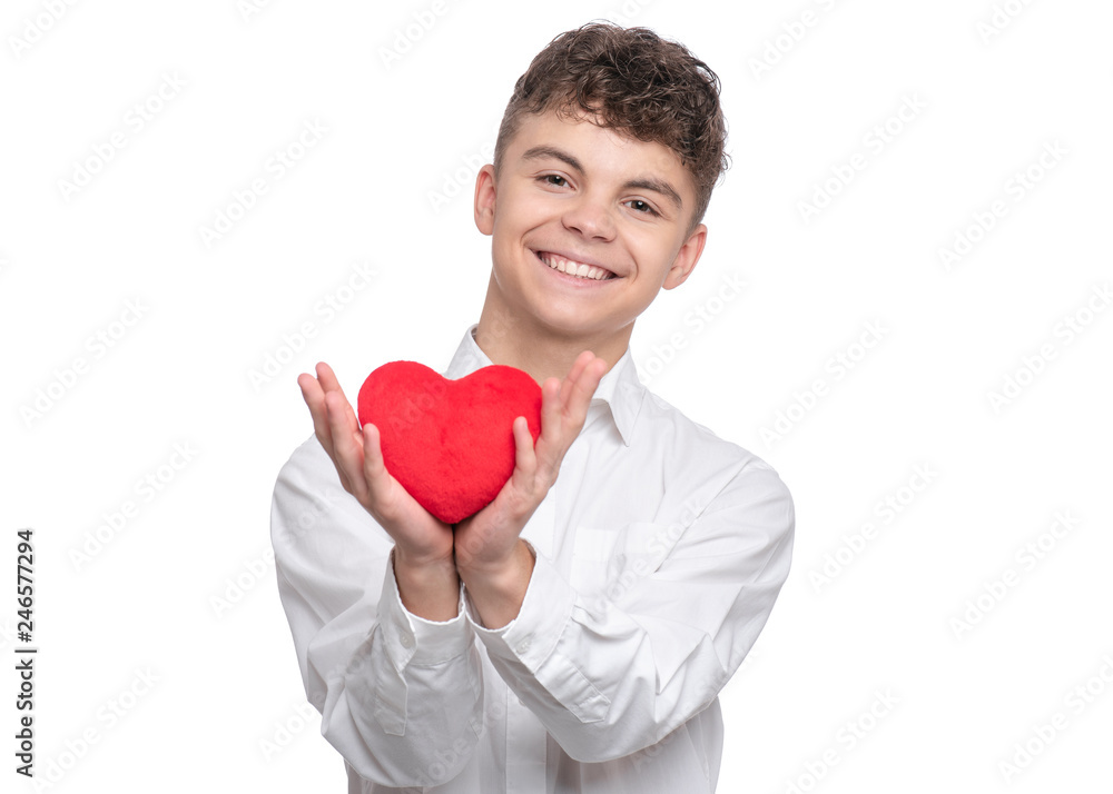 Happy Valentines Day. Cute young Teen Boy in Love with Red plush Heart in his hands. Smiling Child looking at camera, isolated on white background. Happy Valentines Day. Cute young Teen Boy in Love with Red plush Heart in his hands. Smiling Child looking at camera, isolated on white background.