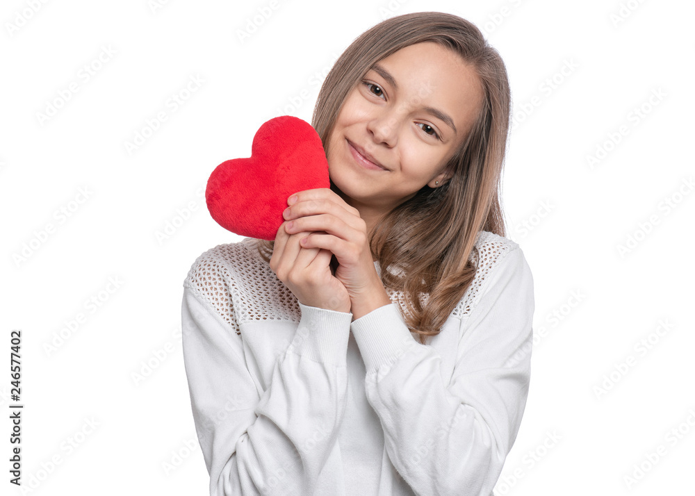 Happy Valentines Day. Cute young Teen Girl in Love with Red plush Heart in her hands. Smiling Child looking at camera, isolated on white background. Happy Valentines Day. Cute young Teen Girl in Love with Red plush Heart in her hands. Smiling Child looking at camera, isolated on white background.