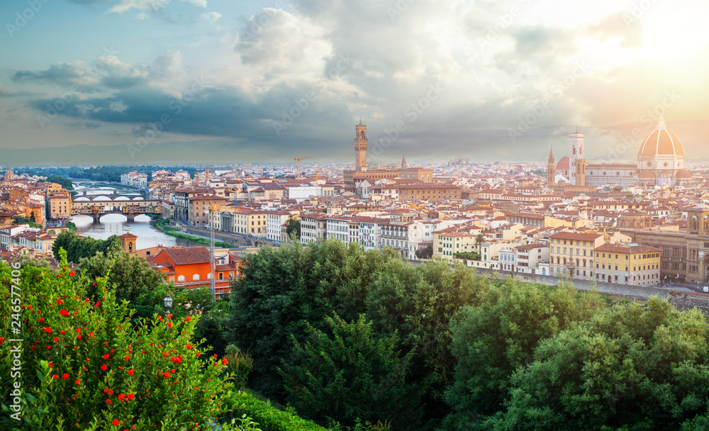 Firenze. Florence landmarks. Cityscape skyline of Florence Italy with Duomo, Basilica di Santa Maria del Fiore and the bridges over the river Arno against cloudy sky.