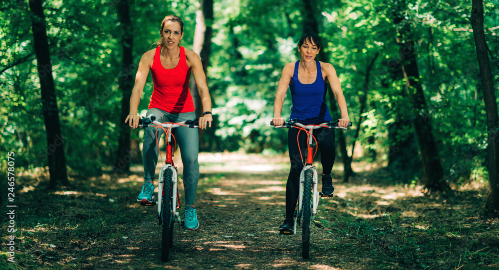 Naklejka premium Two Women Cycling Together