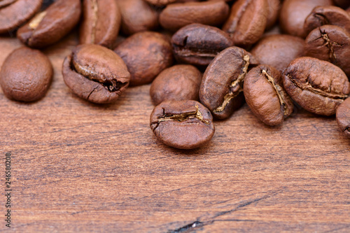 coffee beans on a wooden background scattered