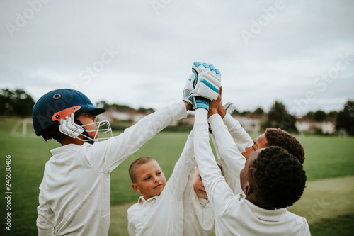 Group of young cricketers doing a high five