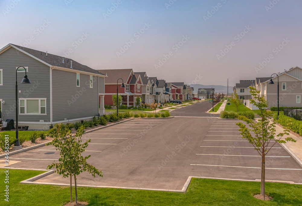 HOmes and parking lot against mountain and sky