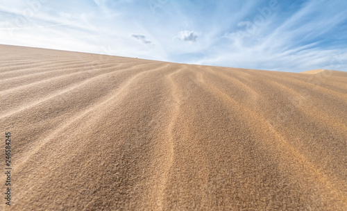 White sand dunes and blue sky background in Mui Ne , South of Vietnam