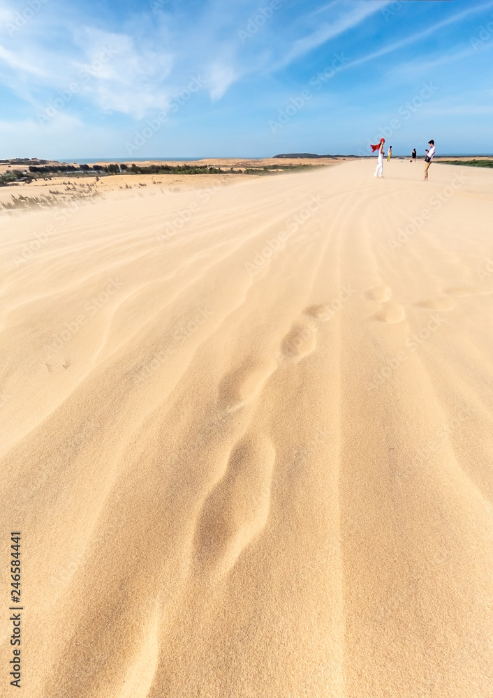 MUI NE, VIETNAM - JANUARY 18, 2019 : Unidentified tourists are traveling white sand dune desert at Mui Ne, Vietnam