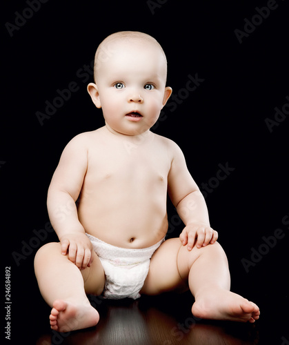 happy baby isolated against black background