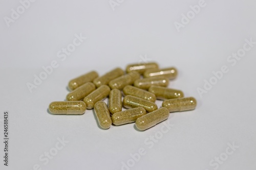 Closeup herbs supplement capsules 410 mg isolated with white background 