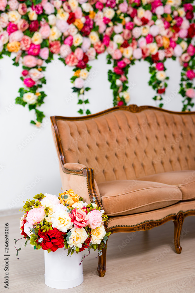 bouquet of beautiful summer flowers and vintage sofa
