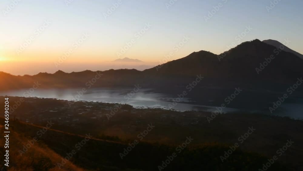 fantastic landscape orange rising sun lights hill slope among dark high mountains and valley with town in morning fog fantastic landscape orange rising sun lights hill slope among dark high mountains and valley with town in morning fog