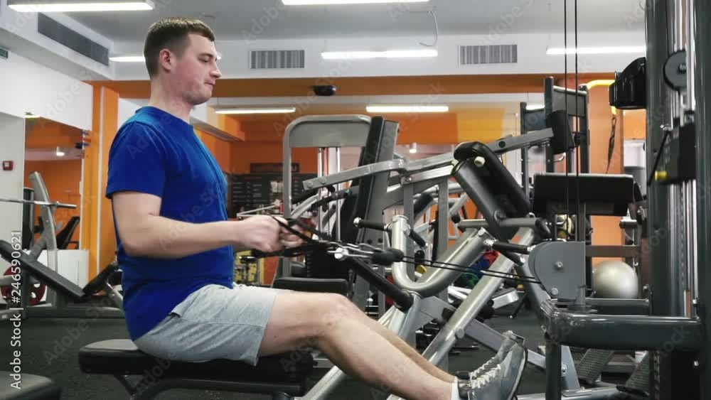 Buisness man doing Back Top Lower workout on bar machine in gym. Right side long shot Buisness man doing Back Top Lower workout on bar machine in gym. Right side long shot