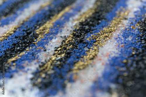 Layered blur sand pattern. Marble style background. Blue and gold powder defocused texture.