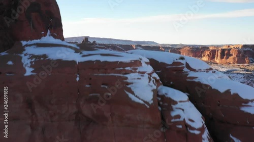 Flying over mountain in Arches National Park covered in snow in winter photo