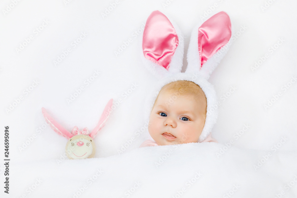 Adorable cute newborn baby girl in Easter bunny costume and ears. Lovely  child playing with plush rabbit toy. Holiday concept. Stock Photo | Adobe  Stock
