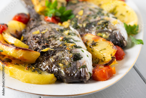 Portata di orate al forno con patate e pomodorini  photo